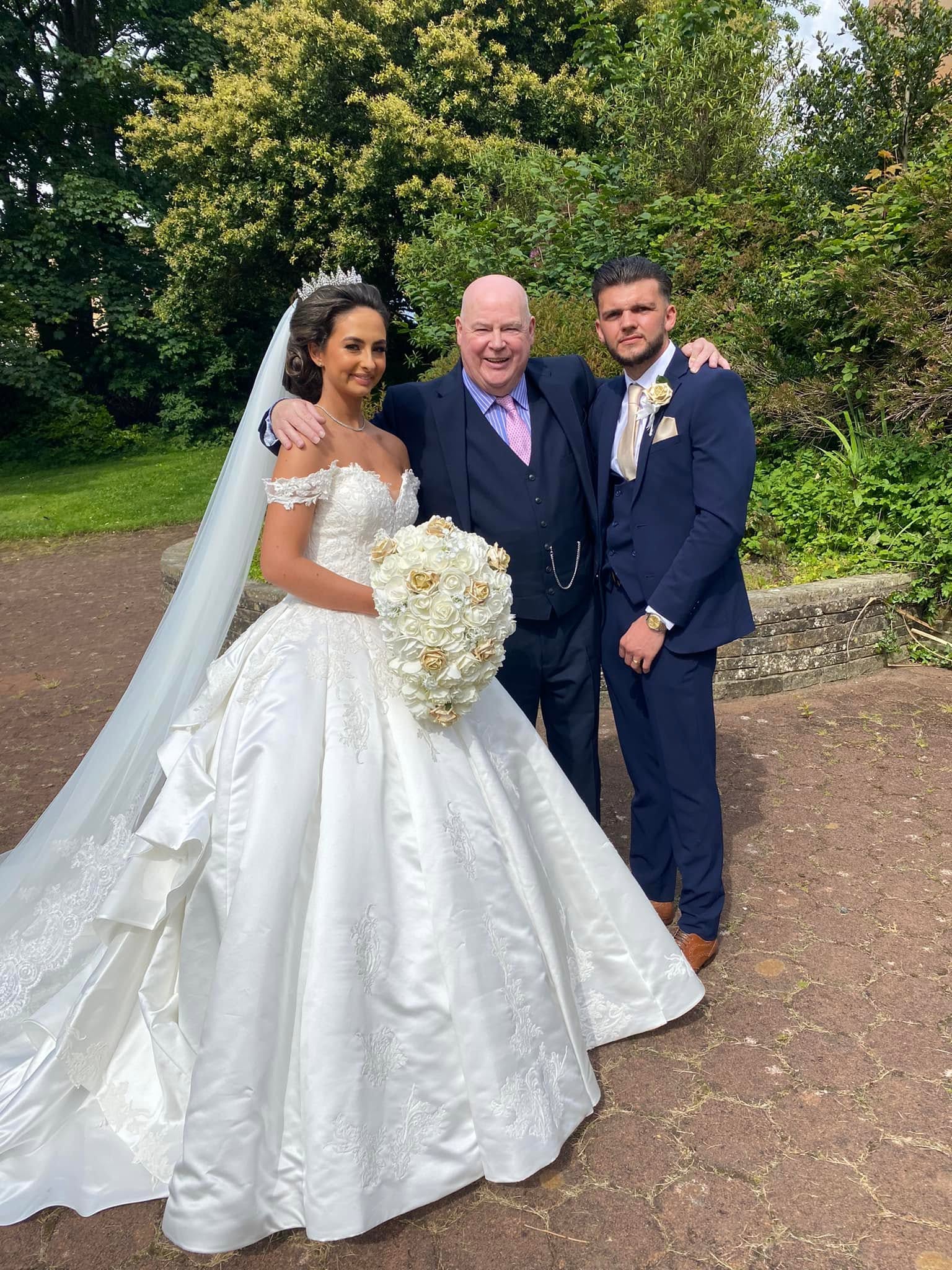 Duncan Fleming with a bride and groom on their wedding day